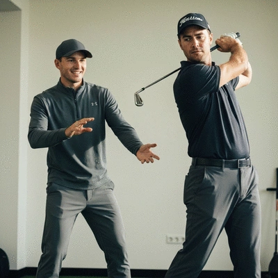 A golf fitness coach guiding a golfer through a specific exercise, emphasizing proper form and technique, in a professional training environment. Focused, instructional, no text, no words, no typography, 8K.